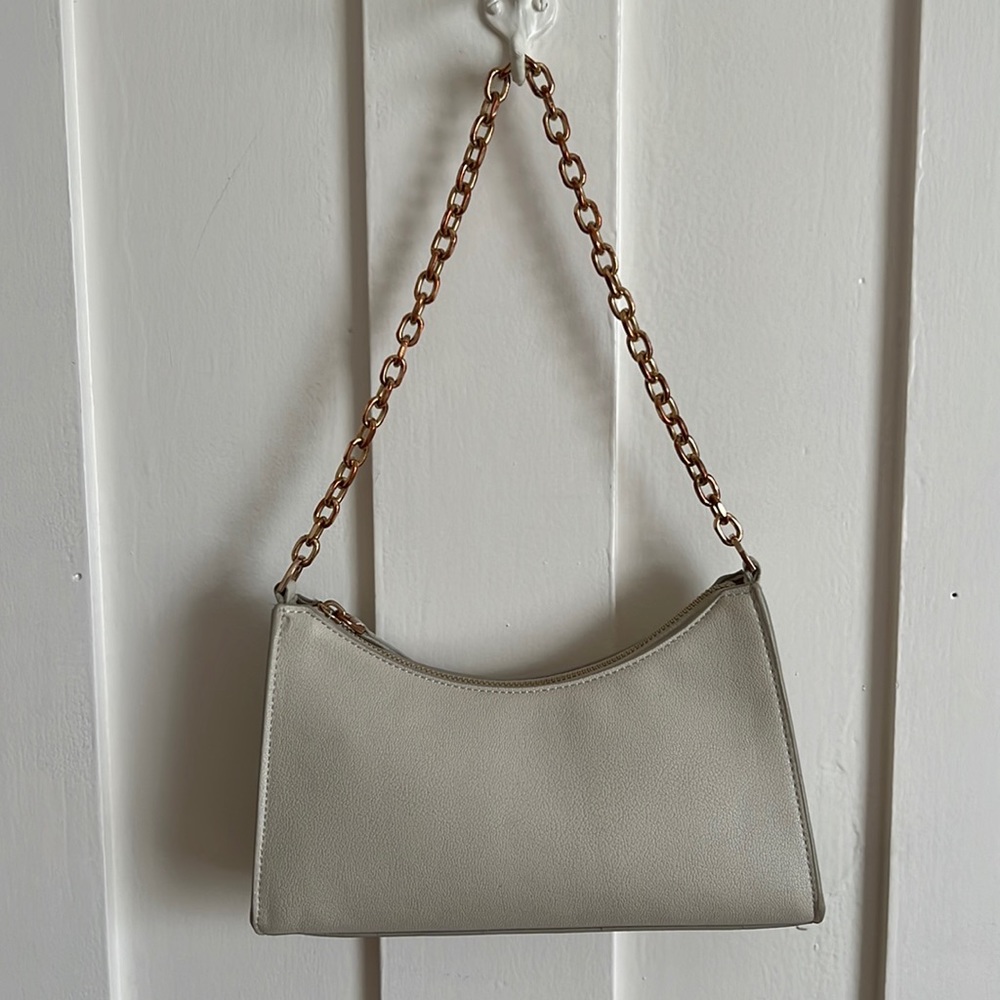 off-white baguette bag with rose gold hardware and additional crossbody strap